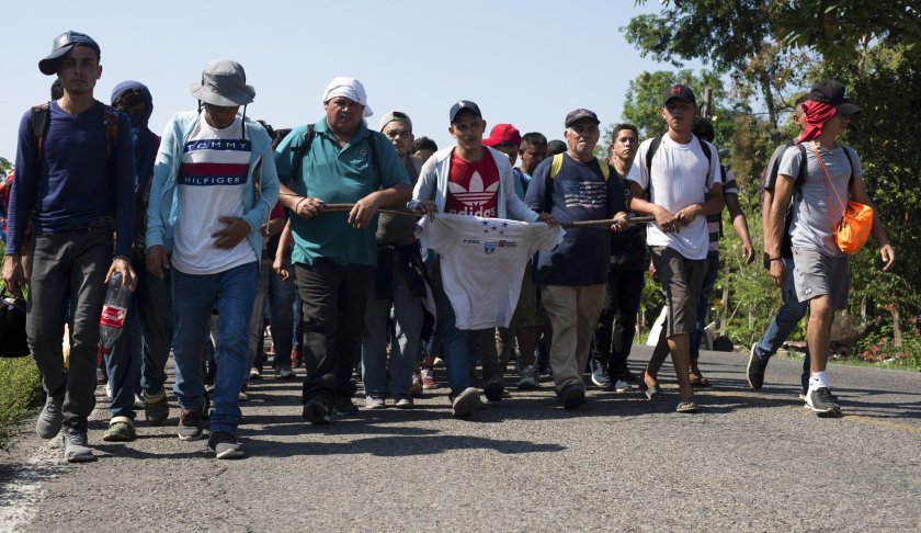Central American migrants, part of a caravan hoping to reach the U.S. border, walk on a road in Frontera Hidalgo, Mexico, Friday, April 12, 2019. The group pushed past police guarding the bridge and joined a larger group of about 2,000 migrants who are walking toward Tapachula, the latest caravan to enter Mexico. (AP Photo/Isabel Mateos)