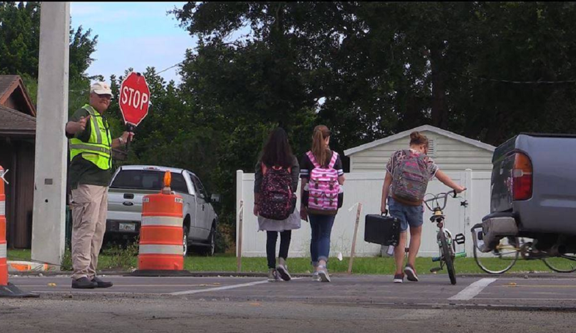 Crossing guard safely directs children across the street. (Credit: Charlotte County Sheriff's Office)