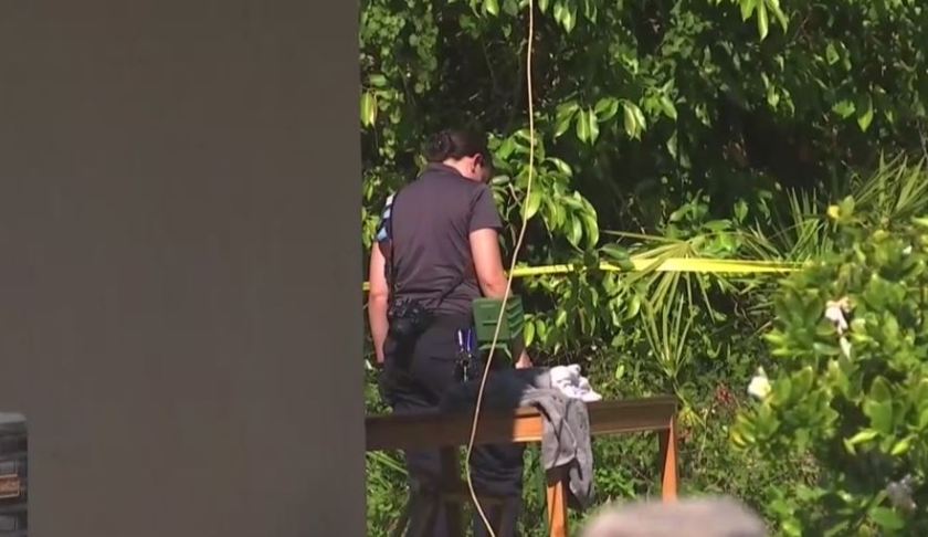 Officer stands before the table where a person died. (Credit: WINK News)
