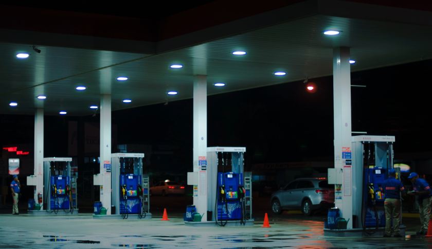Person fuels a car at a gas station (Credit: Juan Fernandez/Unsplash)