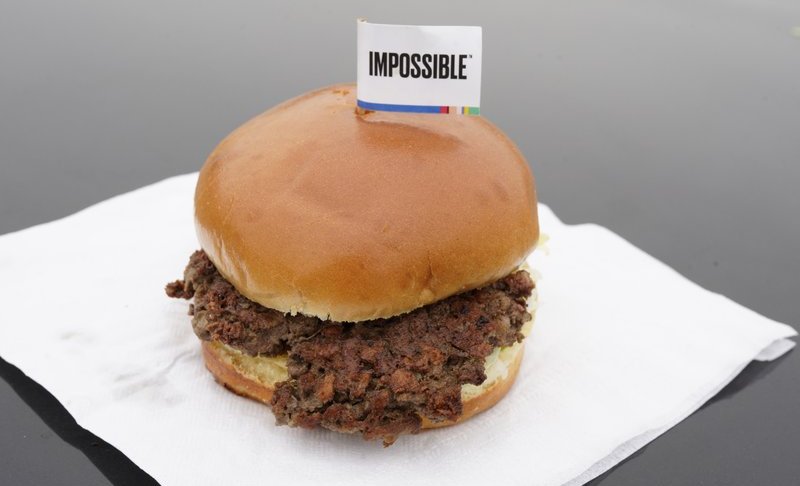 FILE- This Jan. 11, 2019, file photo shows the Impossible Burger, a plant-based burger containing wheat protein, coconut oil and potato protein among it's ingredients in Bellevue, Neb. From soy-based sliders to ground lentil sausages, plant-based meat substitutes are surging in popularity. Growing demand for healthier, more sustainable food is one reason people are seeking plant-based meats. (AP Photo/Nati Harnik, File)
