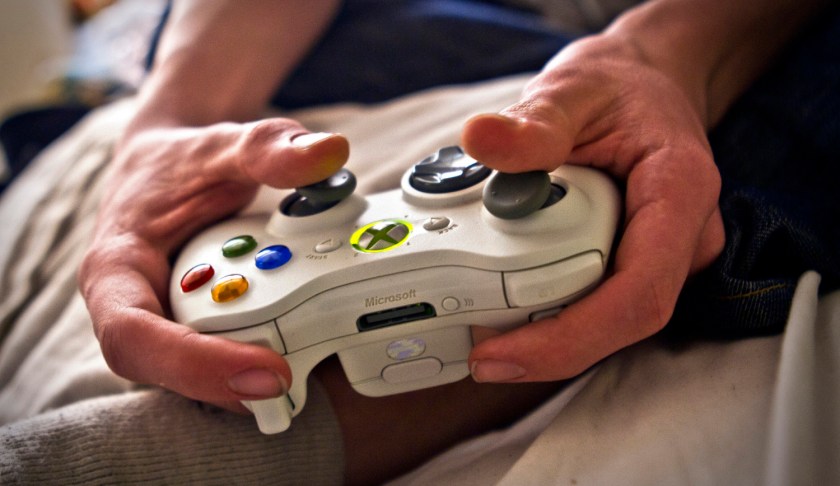 Person plays video games on an Xbox. (Credit: CBS News)