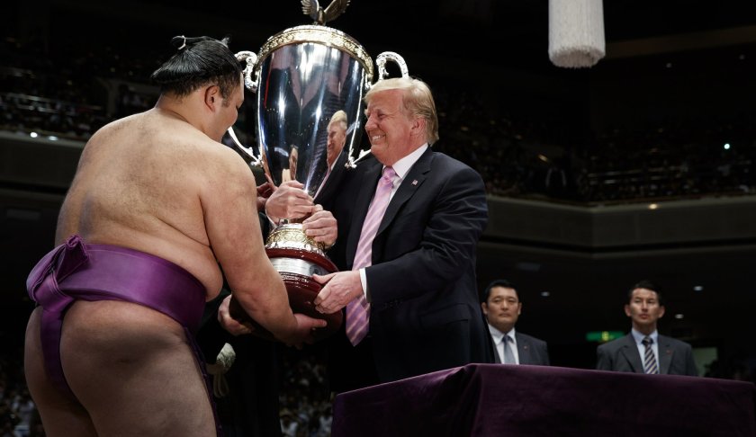 President Donald Trump presents the "President's Cup" to the Tokyo Grand Sumo Tournament winner Asanoyama, at Ryogoku Kokugikan Stadium, Sunday, May 26, 2019, in Tokyo. (AP Photo/Evan Vucci)