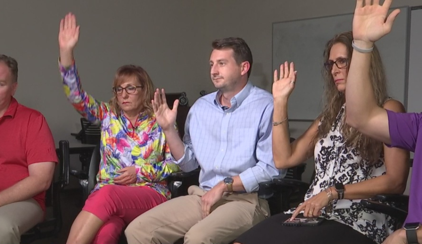 Teachers raise their hands about having looked for a second job. (Credit: WINK News)
