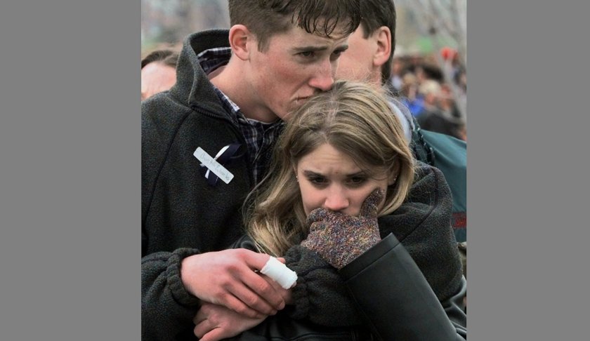 FILE - In this April 25, 1999 file photo, shooting victim Austin Eubanks hugs his unidentified girlfriend during a community wide memorial service in Littleton, Colo., for the victims of the shooting rampage at Columbine High School the previous week. Eubanks, who survived the 1999 Columbine school shooting and later became an advocate for fighting addiction has died. Routt County Coroner Robert Ryg said Saturday, May 18, 2019, that 37-year-old Eubanks died overnight at his Steamboat Springs home. A Monday autopsy was planned to determine the cause of death. (AP Photo/Bebeto Matthews, File)
