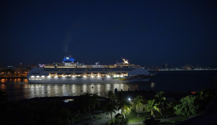 A ship of the Norwegian Cruise Line leaves the bay of Havana at dawn, in Havana, Cuba, Wednesday, June 5, 2019. The Trump administration has imposed major new travel restrictions on visits to Cuba by U.S. citizens, banning stops by cruise ships and ending a heavily used form of educational travel as it seeks to further isolate the communist government. (AP Photo/Ramon Espinosa)