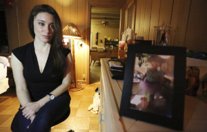 Casey Anthony poses for a portrait next to a photo of her daughter, Caylee, in her West Palm Beach, Fla., bedroom. (AP Photo/Joshua Replogle).
