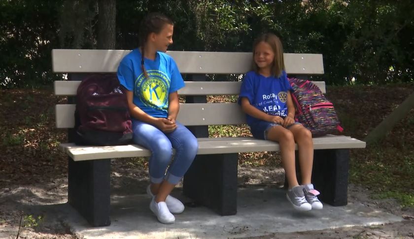 Kids sitting on the new concrete bench. (Credit: WINK News)