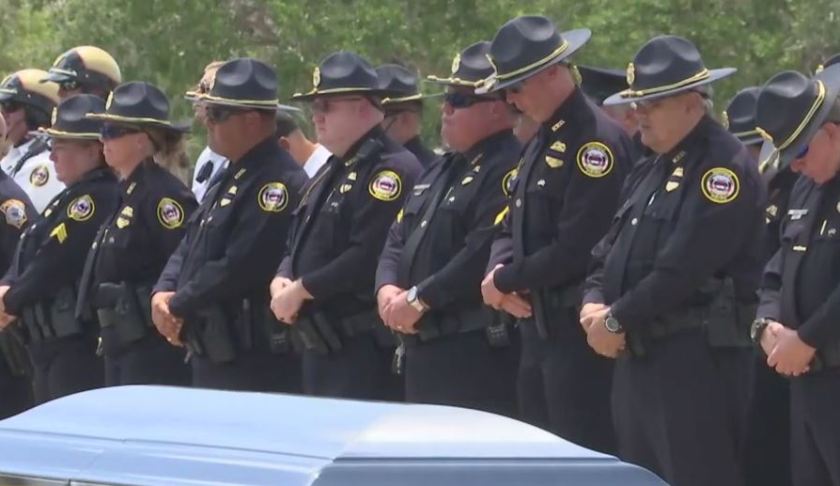 Officers honor the fallen hero. (Credit: WINK News)