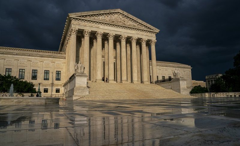FILE - In this June 20, 2019 file photo, the Supreme Court is seen under stormy skies in Washington. Two issues that could determine the distribution of political power for the next decade await resolution on the Supreme Court's final day of decisions before a long summer break. Chief Justice John Roberts could well be the author of decisions on both politically charged topics Thursday, June 27, whether to allow a citizenship question on the 2020 census and place limits on drawing electoral districts for partisan gain. (AP Photo/J. Scott Applewhite, File)