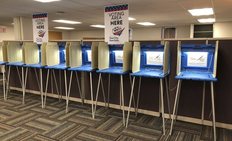 In this Sept. 20, 2018 photo, voting booths stand ready in downtown Minneapolis for the opening of early voting in Minnesota. A majority of Americans are concerned that a foreign government might interfere in some way in the 2020 presidential election, whether by tampering with election results, stealing information or by influencing candidates or voter opinion, a new poll shows.(AP Photo/Steve Karnowski)