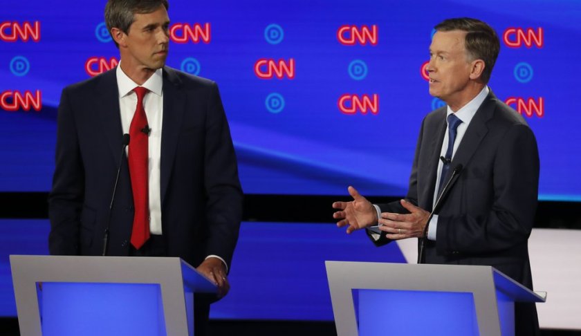 Former Texas Rep. Beto O'Rourke listens as former Colorado Gov. John Hickenlooper speaks during the first of two Democratic presidential primary debates hosted by CNN Tuesday, July 30, 2019, in the Fox Theatre in Detroit. (AP Photo/Paul Sancya)
