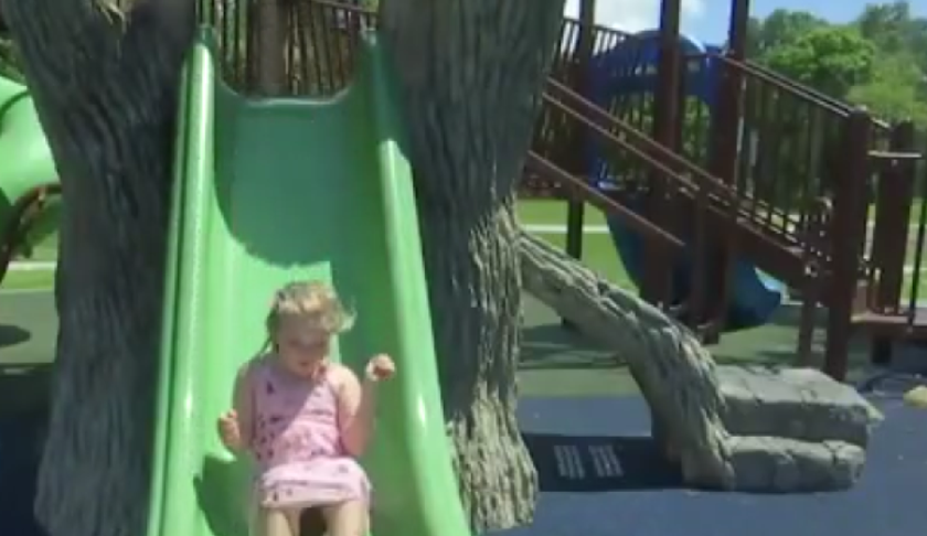 Girl slides down the slide on a playground. (Credit: WINK News).