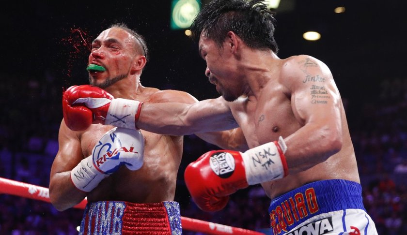 Manny Pacquiao, right, lands a punch against Keith Thurman in the fifth round during a welterweight title fight Saturday, July 20, 2019, in Las Vegas. (AP Photo/John Locher)