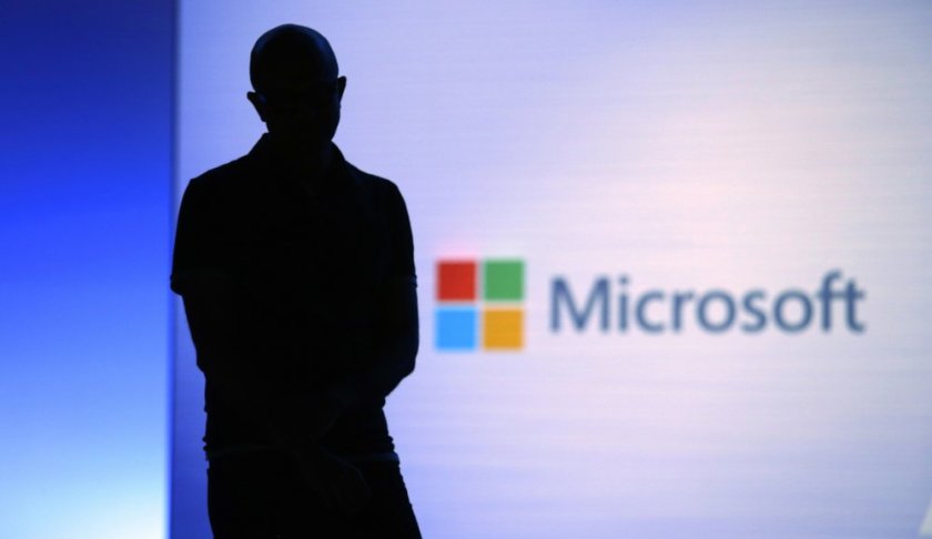 FILE- In this May 7, 2018, file photo Microsoft CEO Satya Nadella looks on during a video as he delivers the keynote address at Build, the company's annual conference for software developers in Seattle. Microsoft is paying more than $25 million to settle federal corruption charges involving a bribery scheme in its Hungary office and three other foreign subsidiaries, the U.S. Securities and Exchange Commission said Monday, July 22, 2019. (AP Photo/Elaine Thompson, File)