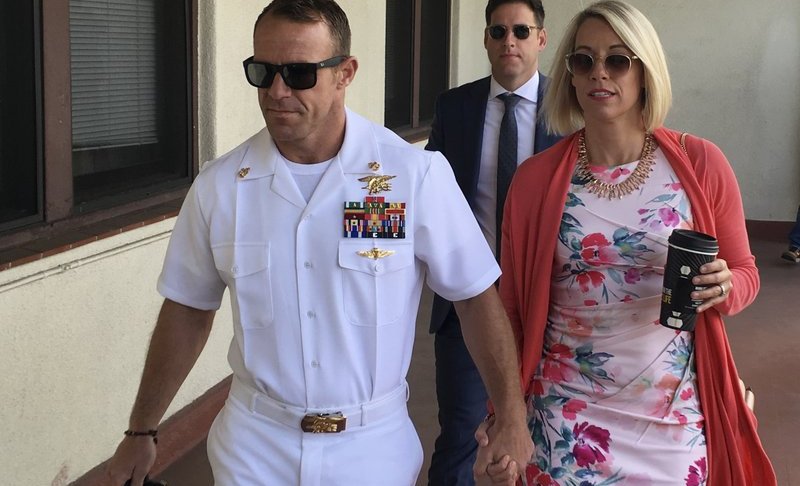 Navy Special Operations Chief Edward Gallagher, left, walks with his wife, Andrea Gallagher as they arrive to military court on Naval Base San Diego, Monday, July 1, 2019, in San Diego. The trial continued Monday in the court-martial of the decorated Navy SEAL, who is accused of stabbing to death a wounded teenage Islamic State prisoner and wounding two civilians in Iraq in 2017. He has pleaded not guilty to murder and attempted murder, charges that carry a potential life sentence. (AP Photo/Julie Watson)