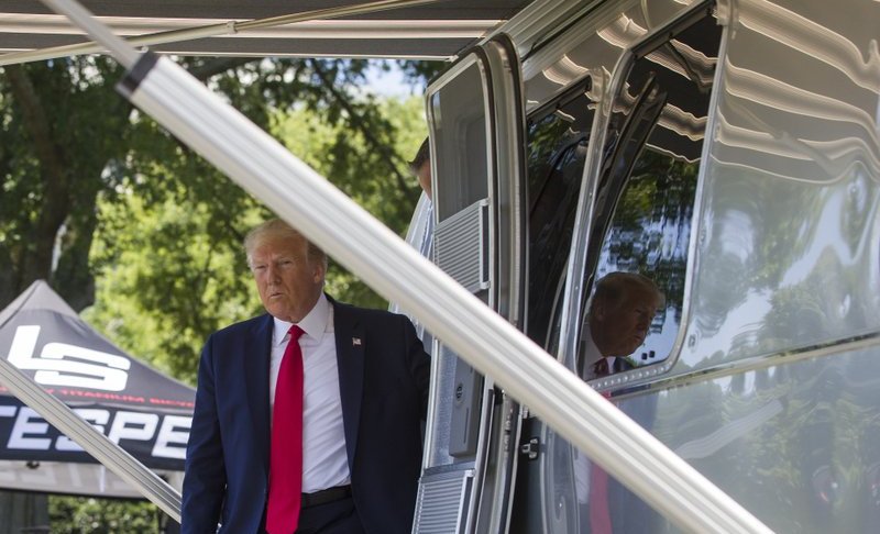 President Donald Trump steps out of an Airstream trailer from Ohio, during a Made in America showcase on the South Lawn of the White House, Monday, July 15, 2019, in Washington. (AP Photo/Alex Brandon)