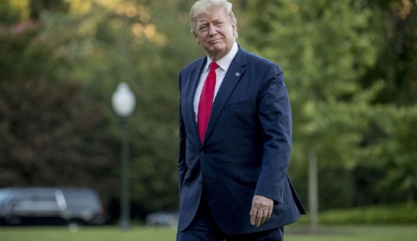 FILE - In this June 30, 2019 file photo, President Donald Trump walks across the South Lawn as he arrives at the White House in Washington. Trump is accusing China and Europe of playing a “big currency manipulation game.” He says the United States should match that effort, a move that directly contradicts official U.S. policy not to manipulate the dollar’s value to gain trade advantages. (AP Photo/Andrew Harnik, File)