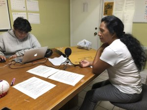 Natividad Jimenez, a volunteer at the Guatemalan-Maya Center, sits in front of a microphone listening to a message she recorded in an Ancient Maya language to urge immigrants to get water, cash, and gas and follow evacuation orders ahead of Hurricane Dorian on on Friday, Aug. 30, 2019 in Lake Worth, Fla. Charity groups are worried about vulnerable populations along the eastern coast, who were still in the cone of potential storm pathway forecast by the National Hurricane Center in Miami. (AP PhotoAdriana Gomez)