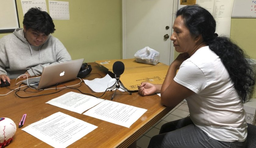 Natividad Jimenez, a volunteer at the Guatemalan-Maya Center, sits in front of a microphone listening to a message she recorded in an Ancient Maya language to urge immigrants to get water, cash, and gas and follow evacuation orders ahead of Hurricane Dorian on on Friday, Aug. 30, 2019 in Lake Worth, Fla. Charity groups are worried about vulnerable populations along the eastern coast, who were still in the cone of potential storm pathway forecast by the National Hurricane Center in Miami. (AP PhotoAdriana Gomez)