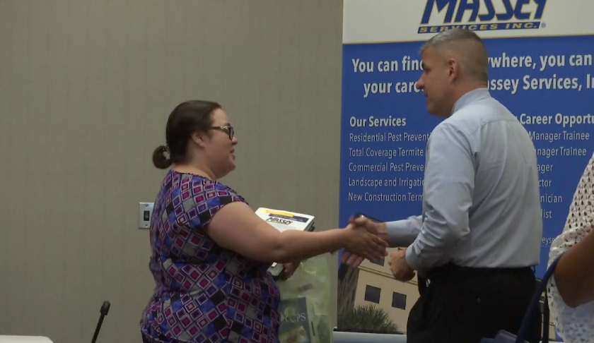Caroline Beltran shakes hands with a potential employer at a Lee County job fair on Wednesday. (Credit: WINK News)