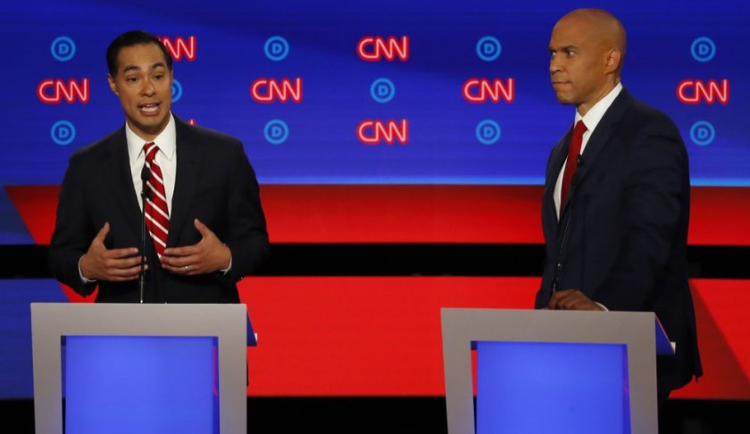 Former Housing and Urban Development Secretary Julian Castro speaks as Sen. Cory Booker, D-N.J. listens during the second of two Democratic presidential primary debates hosted by CNN Wednesday, July 31, 2019, in the Fox Theatre in Detroit. (AP Photo/Paul Sancya)