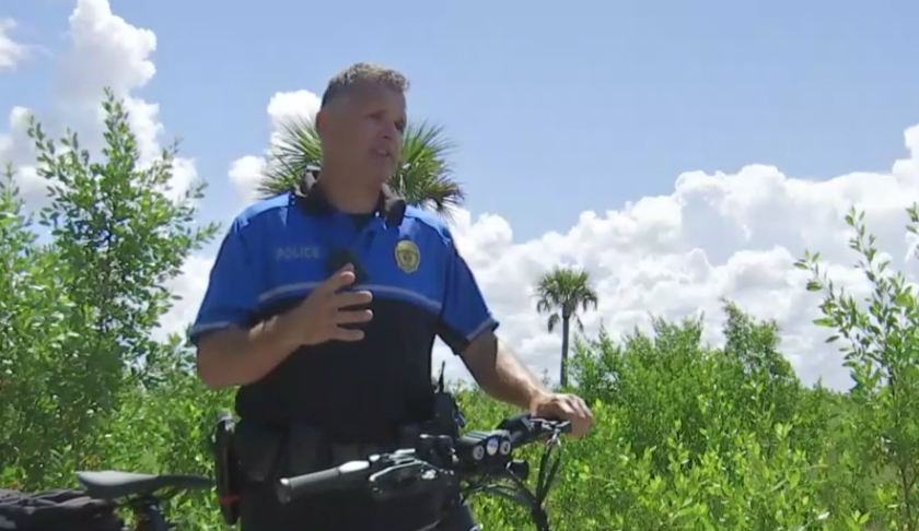 Lt. Michael O'Reilly of the Naples Police Dept. stands by his electric bike. (Credit: WINK News)