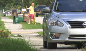 Parked car in a Cape Coral neighborhood blocks the sidewalk. (Credit: WINK News)