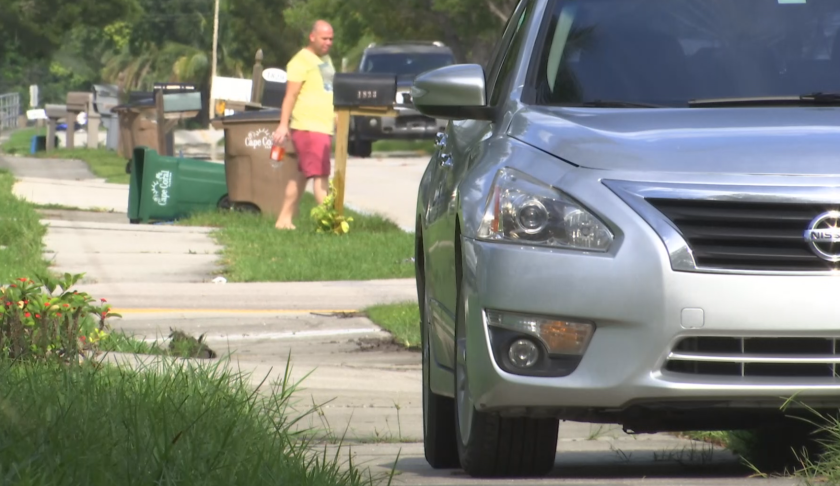 Parked car in a Cape Coral neighborhood blocks the sidewalk. (Credit: WINK News)