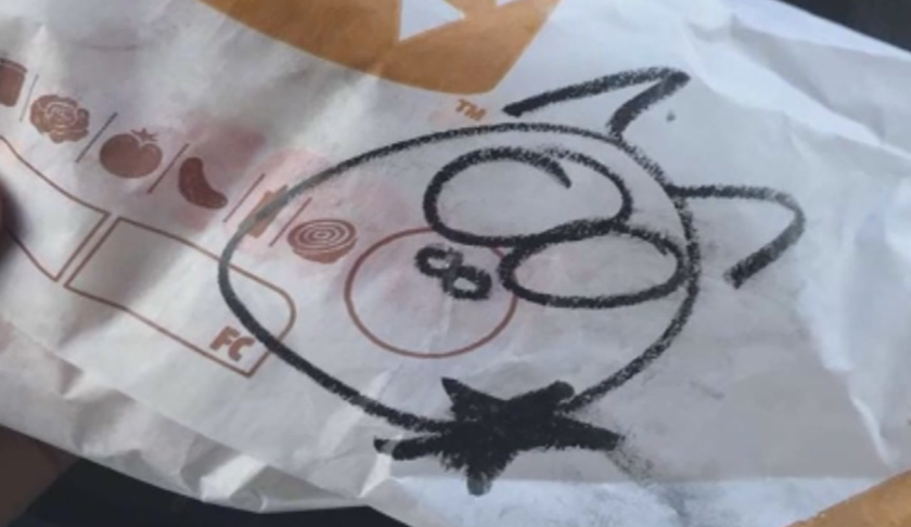 The drawing a New Mexico police officer found on his order. Someone drew a pig on his burger wrapper. (Credit: CNN)