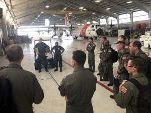Coast Guard air crews and health service technicians are briefed at Coast Guard Air Station Clearwater before a C-130 flight to Andros Island in preparation for Hurricane Dorian response, Sept. 2, 2019. The Coast Guard prestages and relocates personnel and assets to be able to have a rapid post-storm response. (U.S. Coast Guard photo by Petty Officer 1st Class Ayla Kelley.)