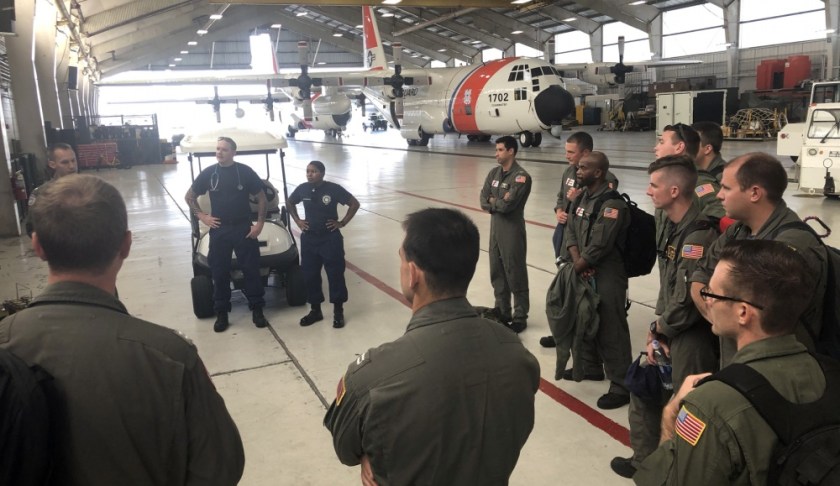 Coast Guard air crews and health service technicians are briefed at Coast Guard Air Station Clearwater before a C-130 flight to Andros Island in preparation for Hurricane Dorian response, Sept. 2, 2019. The Coast Guard prestages and relocates personnel and assets to be able to have a rapid post-storm response. (U.S. Coast Guard photo by Petty Officer 1st Class Ayla Kelley.)