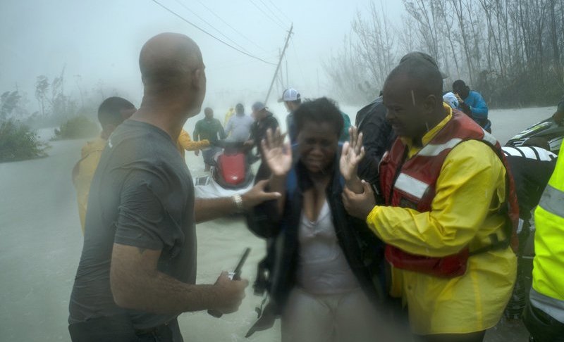 Volunteers rescue several families that arrived on small boats, from the rising waters of Hurricane Dorian, near the Causarina bridge in Freeport, Grand Bahama, Bahamas, Tuesday, Sept. 3, 2019. The storm’s punishing winds and muddy brown floodwaters devastated thousands of homes, crippled hospitals and trapped people in attics. (AP Photo/Ramon Espinosa)