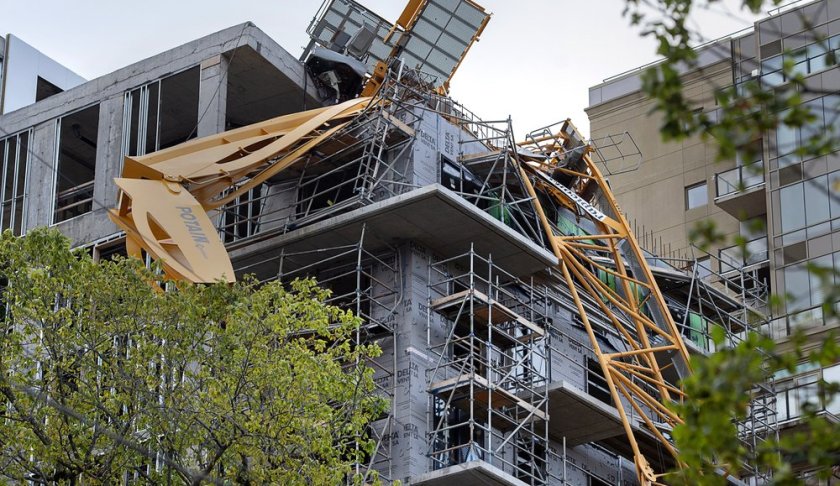 A toppled building crane is draped over a new construction project after Hurricane Dorian swept through the area in Halifax, Nova Scotia, on Sunday, Sept. 8, 2019. Hurricane Dorian brought wind, rain and heavy seas that knocked out power across the region, left damage to buildings and trees as well as disruption to transportation. (Andrew Vaughan/The Canadian Press via AP)