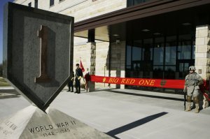 FILE - In this Feb. 9, 2015 file photo, an honor guard stands at the entrance before ribbon cutting ceremonies for the new 1st Infantry Division Headquarters at Fort Riley, Kan. Prosecutors say a U.S. Army infantry soldier stationed at Fort Riley shared bomb-making instructions online and also discussed killing activists and bombing a news network. The Justice Department says Monday, Sept. 23, 2019, that private first class Jarrett William Smith was charged with distributing information related to explosives and weapons of mass destruction. (AP Photo/Orlin Wagner File)