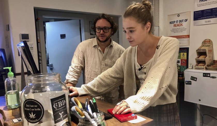 In this photo taken Sept. 20, 2019, David Alport, owner of the Bridge City Collective marijuana dispensary in Portland, Ore., goes over sales numbers with the store's general manager Cameron Moore. The company has seen a 31% decrease in its sales of vaping products in the past two weeks. “It’s having an impact on how consumers are behaving,” said Alport. “People are concerned, and we’re concerned.” (AP Photo/Gillian Flaccus)