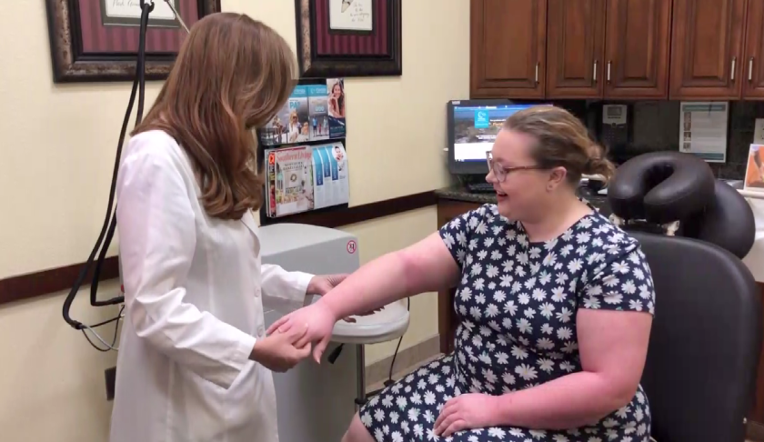 Dr. Aurora Badia checks her patient, Breanna Brown, for her eczema treatment. (Credit: WINK News)