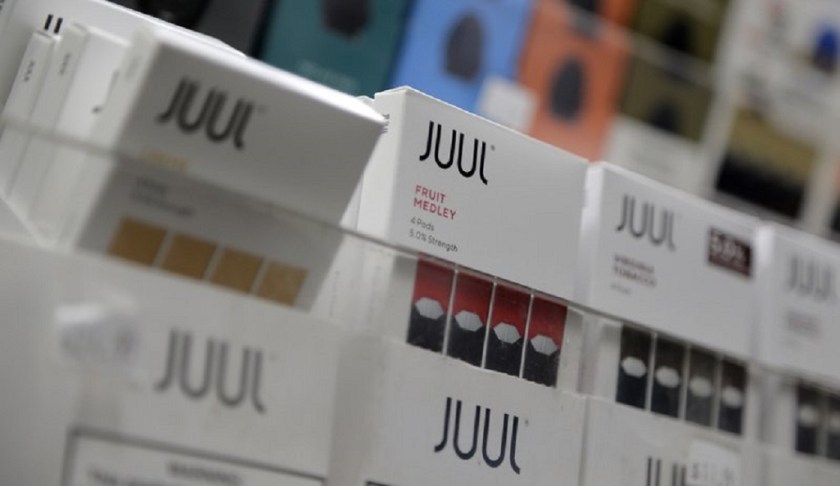 FILE - In this Dec. 20, 2018, file photo Juul products are displayed at a smoke shop in New York. Federal health authorities say vaping giant Juul Labs illegally promoted its electronic cigarettes as a safer option to smoking, including in a presentation to school children. The Food and Drug Administration issued a stern warning letter to the company Monday, Sept. 9, 2019, flagging various claims by Juul, including that its products are “much safer than cigarettes.” The FDA has been investigating Juul for months but had not previously warned the company. (AP Photo/Seth Wenig, File)