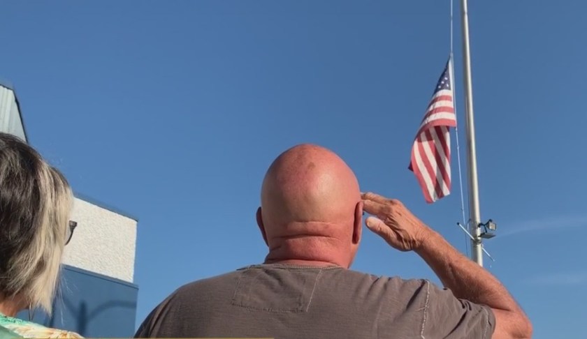 Man salutes the flag on Sept. 11 during a ceremony. (Credit: WINK News)