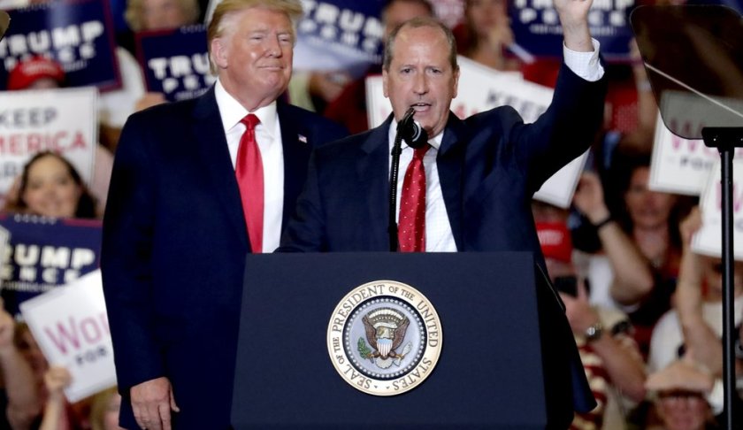 President Donald Trump, left, gives his support to Dan Bishop, right, a Republican running for the special North Carolina 9th District U.S. Congressional race as he speaks at a rally in Fayetteville, N.C., Monday, Sept. 9, 2019. (AP Photo/Chris Seward)