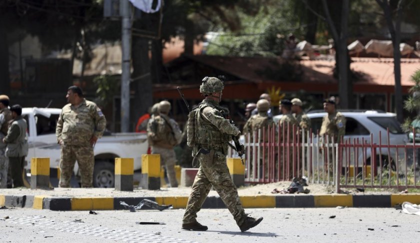 Resolute Support (RS) forces and Afghan security personnel inspect the site of a car bomb explosion in Kabul, Afghanistan, Thursday, Sept. 5, 2019. A car bomb rocked the Afghan capital on Thursday and smoke rose from a part of eastern Kabul near a neighborhood housing the U.S. Embassy, the NATO Resolute Support mission and other diplomatic missions. (AP Photo/Rahmat Gul)