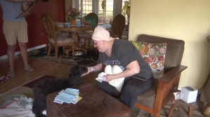 Sandra Scheel has been battling breast cancer for nearly 12 months. She is seen here at her Charlotte County home with her pet. Scheel was scammed out of $2,000. (Credit: WINK News)