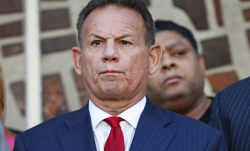 FILE - In this Jan. 11, 2019 file photo, suspended Broward County Sheriff Scott Israel listens to comments by his attorney at a news conference after new Florida Gov. Ron DeSantis suspended Israel in Fort Lauderdale, Fla., over his handling of February's massacre at Marjory Stoneman Douglas High School. Florida Senate special master Dudley Goodlette is recommending that the sheriff suspended over his handling of shootings at a Parkland high school and the Fort Lauderdale airport should be reinstated. (AP Photo/Wilfredo Lee, File)
