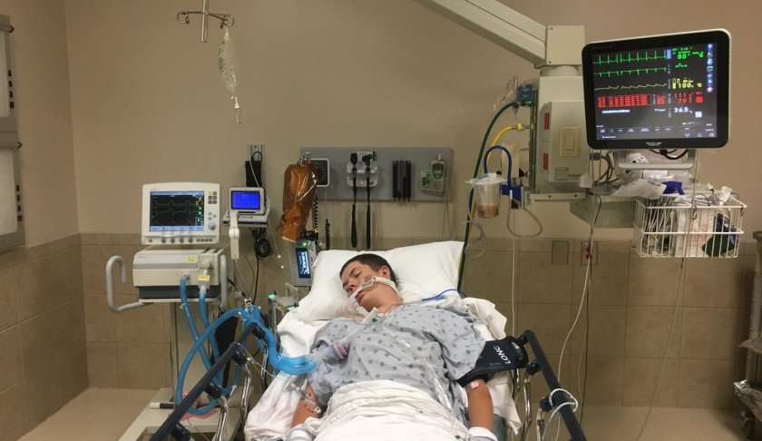 This May 2018, photo provided by Joseph Jenkins shows his son, Jay, in the emergency room of the Lexington Medical Center in Lexington, S.C. Jay Jenkins suffered acute respiratory failure and drifted into a coma, according to his medical records, after he says he vaped a product labeled as a smokable form of the cannabis extract CBD. Lab testing commissioned as part of an Associated Press investigation into CBD vapes showed the cartridge that Jenkins says he puffed contained a synthetic marijuana compound blamed for at least 11 deaths in Europe. (Joseph Jenkins via AP)