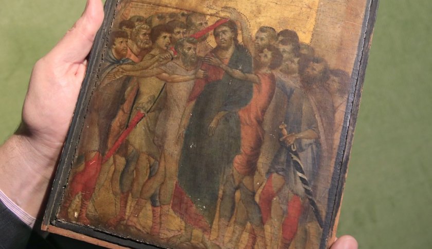 FILE - In this Tuesday, Sept. 24, 2019 file photo, art expert Stephane Pinta points to a 13th-century painting by Italian master Cimabue in Paris, Tuesday, Sept. 24, 2019. A masterpiece attributed to the 13th-century Italian painter Cimabue that was discovered in an elderly French woman's kitchen is expected to sell for millions at auction. Stephane Pinta, a painting specialist with the Turquin gallery in Paris, said an auctioneer spotted the painting while inspecting the woman's house in Compiegne in northern France and suggested she bring it to experts for an evaluation. (AP Photo/Michel Euler, File )