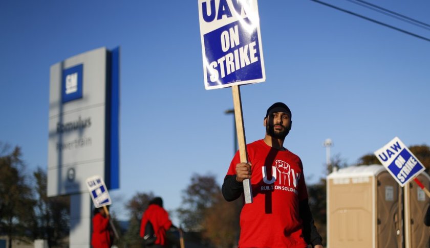 FILE - In this Oct. 9, 2019, file photo a member of the United Auto Workers walks the picket line at the General Motors Romulus Powertrain plant in Romulus, Mich. General Motors CEO Mary Barra joined negotiators at the bargaining table Tuesday, Oct. 15, an indication that a deal may be near to end a monthlong strike by members of the United Auto Workers union that has paralyzed the company’s factories. (AP Photo/Paul Sancya, File)