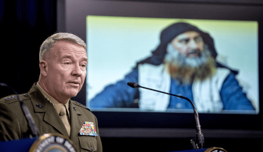 Abu Bakr al-Baghdadi is displayed on a monitor as U.S. Central Command Commander Marine Gen. Kenneth McKenzie speaks at a joint press briefing at the Pentagon in Washington, Wednesday, Oct. 30, 2019, on the Abu Bakr al-Baghdadi raid. (ANDREW HARNIK / AP)
