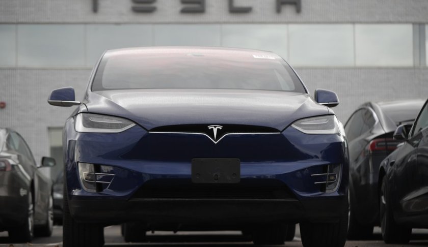 In this Sunday, Oct. 20, 2019, photo an unsold 2019 Model X sits under a sign at a Tesla dealership in Littleton, Colo. Tesla reports financial earns on Wednesday, Oct. 23. (AP Photo/David Zalubowski)