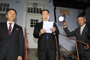 North Korean negotiator Kim Miyong Gil, center, reads statement outside the North Korean Embassy in Stockholm, Sweden, Saturday, Oct. 5, 2019. North Korea's chief negotiator said Saturday that discussions with the U.S. on Pyongyang's nuclear program have broken down, but Washington said the two sides had "good discussions" that it intends to build on in two weeks. (Kyodo News via AP)