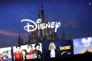 A Disney logo forms part of a menu for the Disney Plus movie and entertainment streaming service on a computer screen in Walpole, Mass., Wednesday, Nov. 13, 2019. Disney Plus says it hit more than 10 million sign-ups on its first day of launch, far exceeding expectations. (AP Photo/Steven Senne)